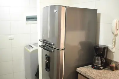 a stainless steel refrigerator in a kitchen with a phone at Luxury apartment with pool in Barranquilla