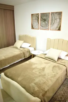 a room with two beds and a table at Luxury apartment with pool in Barranquilla