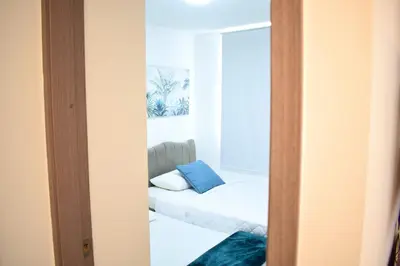 a room with a couch and a mirror at Luxury apartment with pool in Barranquilla