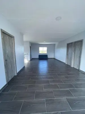 an empty room with a tile floor and a window at Villa Matthew - Villa de Lujo con Piscina Privada y BBQ, Cerca al Mar in Juan de Acosta