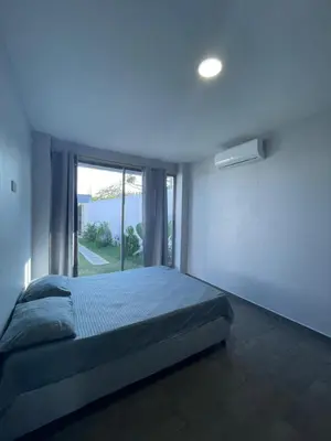 a bedroom with a bed and a large window at Villa Matthew - Villa de Lujo con Piscina Privada y BBQ, Cerca al Mar in Juan de Acosta