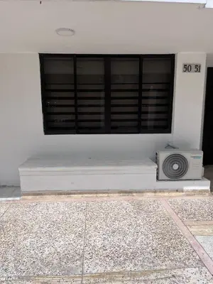 a white building with a window with a radio at Loft Deluxe - Nuevo, Acogedor, Integral, Ubicación inmejorable in Barranquilla