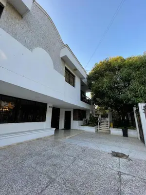 a white building with a tree in front of it at Loft Deluxe - Nuevo, Acogedor, Integral, Ubicación inmejorable in Barranquilla