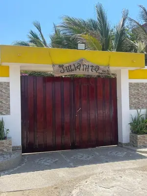 a wooden garage door with a sign on it at Cabaña Julianita in Santa Veronica