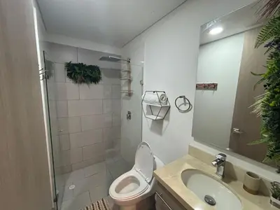 a bathroom with a toilet and a sink and a shower at Apartamento Magno Loft Bocagrande in Cartagena de Indias