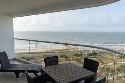 a balcony with a table and chairs and the ocean at Loft apartment with sea view in Cartagena de Indias