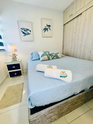 a bedroom with two beds with towels on them at TorrePRIMI1905 in Cartagena de Indias