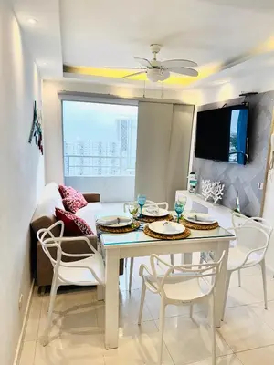 a dining room with a white table and chairs at TorrePRIMI1905 in Cartagena de Indias