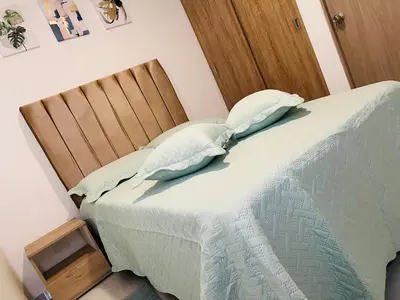 a bed with two pillows on it in a room at Apartamento Marbella Piso 28 - Playa in Cartagena de Indias