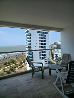 a balcony with two chairs and a view of the beach at Cartagena Beach Exclusive apto in Cartagena de Indias