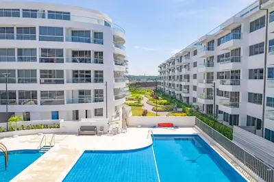 an apartment complex with a swimming pool and a building at Serenity Flat in Puerto Tierrabaja