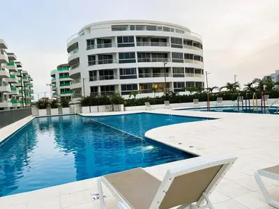 a swimming pool in front of a building at Serenity Flat in Puerto Tierrabaja