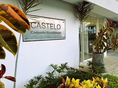 a sign on the side of a building with plants at Serenity Flat in Puerto Tierrabaja