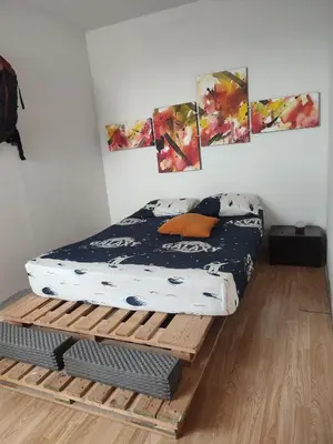 a bed sitting on a wooden platform in a room at Piso apartamento Cartagena de indias in Cartagena de Indias
