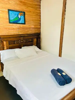 a white bed with two blue towels on it at La playita ocean view in Playa Blanca