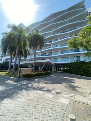 a large building with palm trees in front of it at U-GO Morros epic in Cartagena de Indias