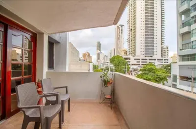 a balcony with chairs and a view of a city at Habitaciones cerca playa Bocagrande in Cartagena de Indias