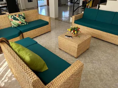 a living room with wicker chairs and a couch at House Villa Las Marias in Juan de Acosta
