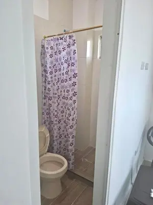 a bathroom with a toilet and a shower curtain at Casa balcones del rio in Barranquilla