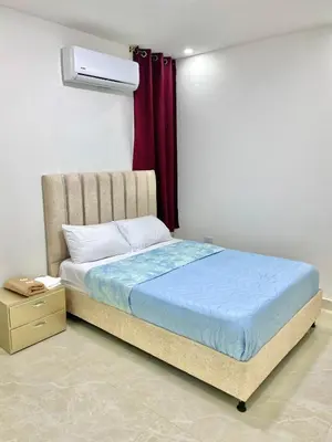 a bed in a room with a red curtain at Casa balcones del rio in Barranquilla