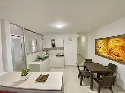 a kitchen and dining room with a table and a dining room at Casa balcones del rio in Barranquilla