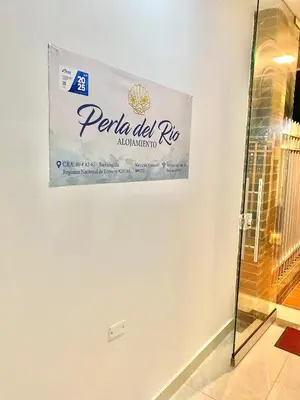 a sign for a restaurant on a wall at Casa balcones del rio in Barranquilla