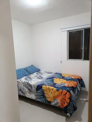 a bed with a colorful comforter in a room at Torre 811 in Cartagena de Indias
