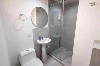 a bathroom with a shower and a toilet and a sink at Cozy apartment in bocagrande in Cartagena de Indias