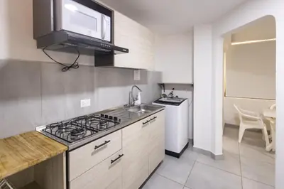 a kitchen with a sink and a stove top oven at Cozy apartment in bocagrande in Cartagena de Indias