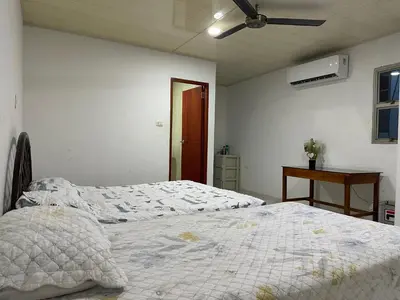 a bedroom with two beds and a ceiling fan at Habitación en Santiago de Tolú in Santiago