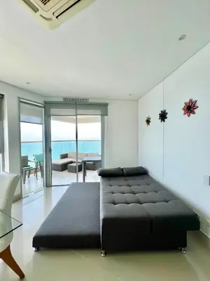 a bedroom with a bed and a living room at Apartamento Palmar in Cartagena de Indias