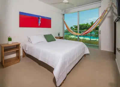 a bedroom with a bed and a large window at Magico Apartamento Frente al Mar 3 Habitaciones MSC22 in Coveñas