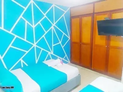 a blue room with a bed and a television at apto al frente del mar p11 in Cartagena de Indias