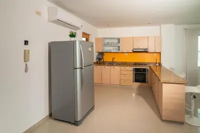 a kitchen with a stainless steel refrigerator at Hermoso Apartamento Frente al Mar 3 Habitaciones B62 in Coveñitas