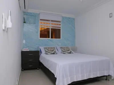 a bedroom with a white bed and a window at Historic Cartagena 2BR Apt in Cartagena de Indias