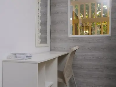a white desk with a chair next to a window at Historic Cartagena 2BR Apt in Cartagena de Indias