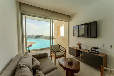 a living room with a couch and a large window at Baia Kristal in Cartagena de Indias