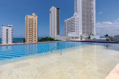 a swimming pool with tall buildings in the background at Cartagena Bella Por Días in Cartagena de Indias