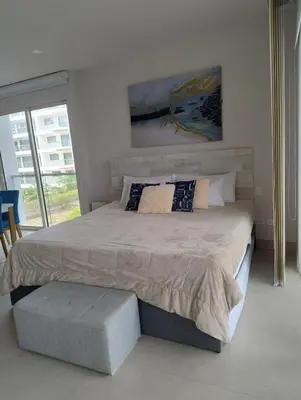 a bedroom with a large bed with a large window at Morros Manzanillo 324 in Cartagena de Indias