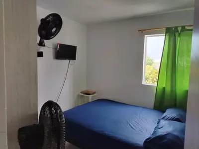 a bedroom with a blue bed and a window at Summer 811 in Cartagena de Indias