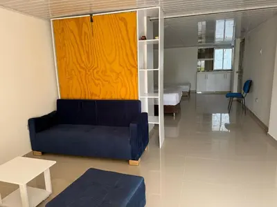 a living room with a couch and a bed at Club House in Maizal