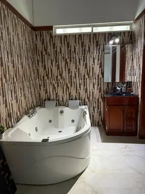 a bath tub in a bathroom with a sink at Hacienda Villa Hermelina-Casa Campestre in Turbaco