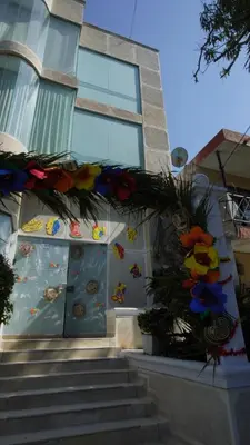 a building with a door with flowers on it at Hostal El Recreo in Barranquilla