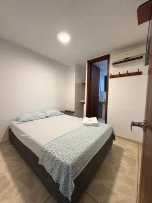 a bedroom with a bed in a room at Hostal El Recreo in Barranquilla