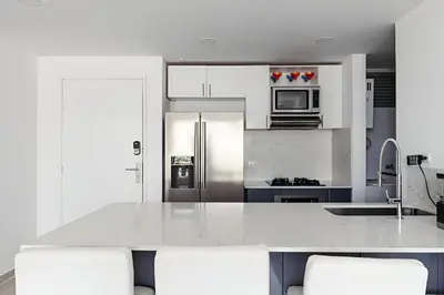 a kitchen with white cabinets and stainless steel appliances at Elegante Apartamento en Cartagena con salida al Mar, Morros Epic in Cartagena de Indias