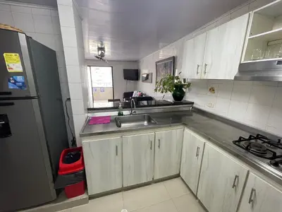 a small kitchen with a sink and a refrigerator at Vista Hermosa Portofino in Cartagena de Indias