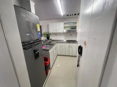 a kitchen with a stainless steel refrigerator and white cabinets at Vista Hermosa Portofino in Cartagena de Indias