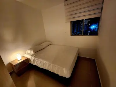 a small bedroom with a bed and a window at New and with an ocean view in Cartagena de Indias