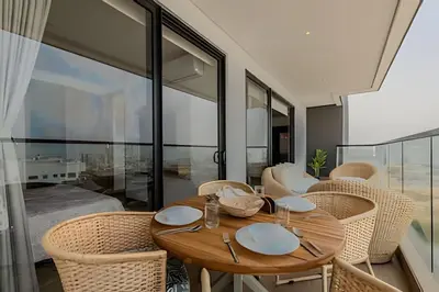 a dining room with a wooden table and chairs at Nuevo Vista al Mar / Centro Histórico Piso 28 in Cartagena de Indias