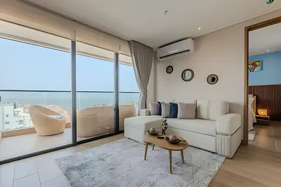 a living room with a white couch and a large window at Nuevo Vista al Mar / Centro Histórico Piso 28 in Cartagena de Indias